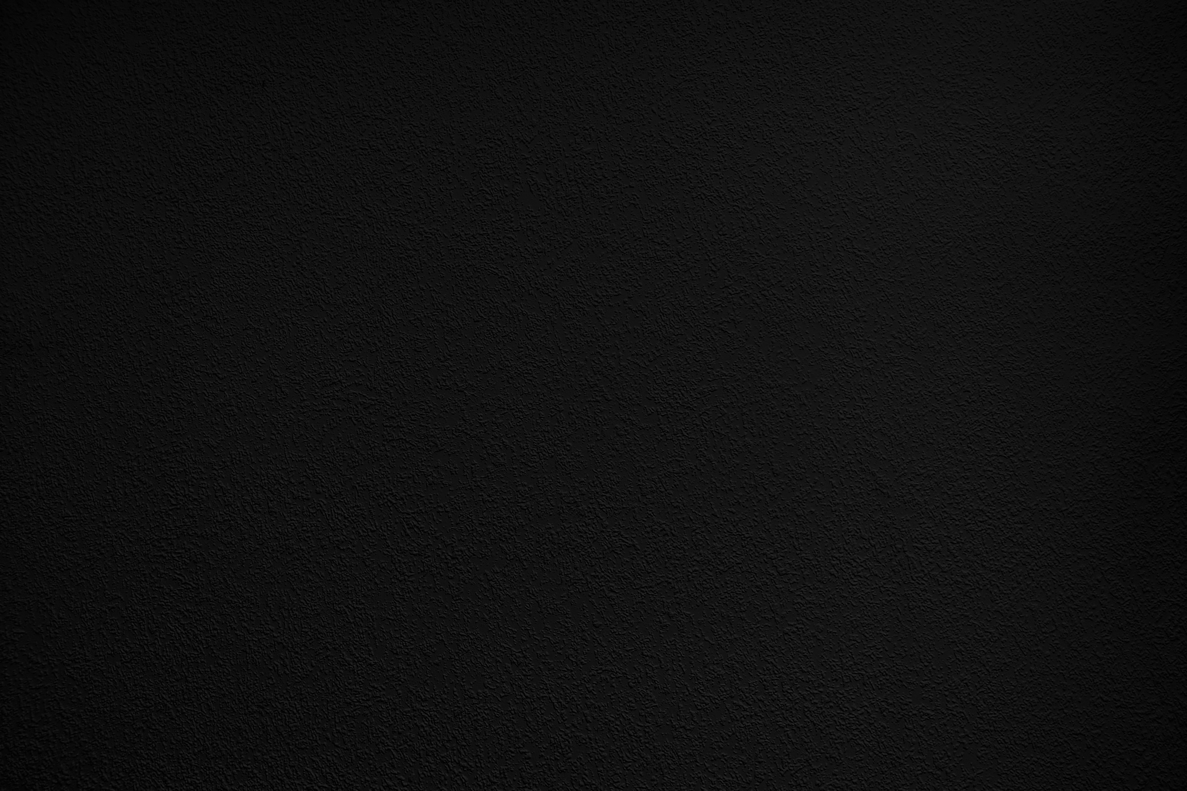 Black Background. Dark Grainy Texture. Wall Surface in the Dark